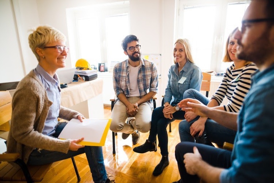 A social worker meets with a group of clients.