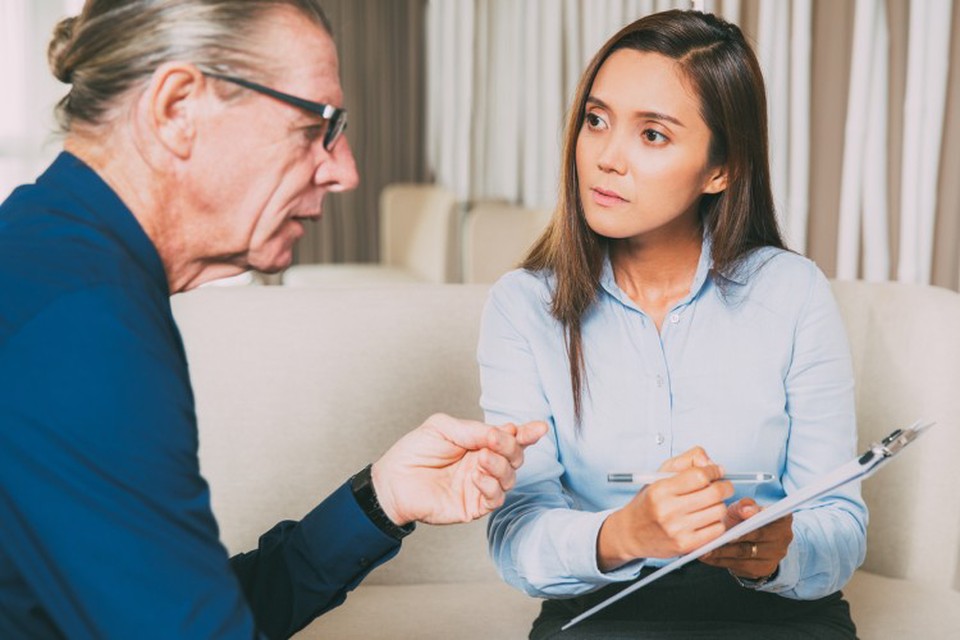 A social worker surveys a community member.