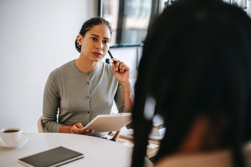 A clinical social worker attentively listens to a client.