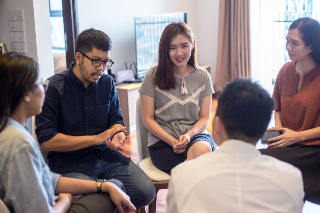 A clinical social worker leads a group therapy session.